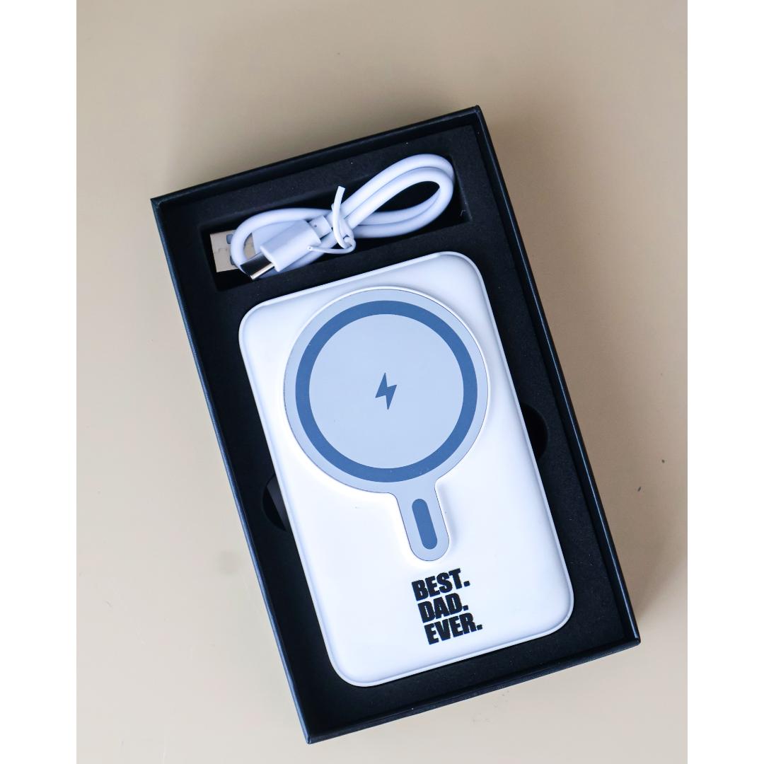 A white portable wireless charger with a blue circular magnetic pad and the text 'BEST DAD EVER'.